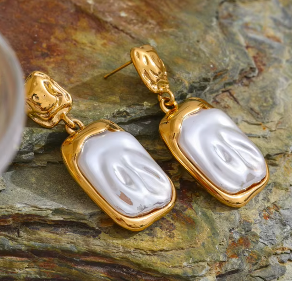 Gold-plated drop earrings with iridescent pearl finish and organic, elongated shape from the RESORT 444 Luxe Latitude Collection.