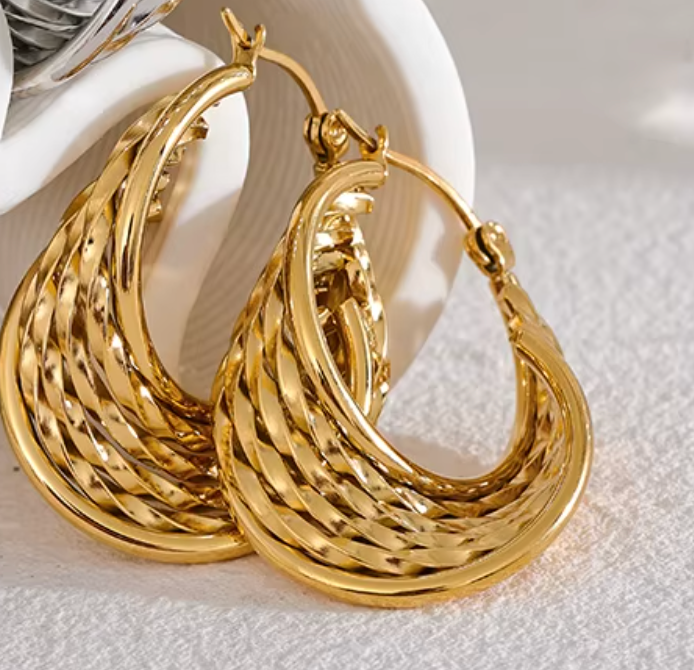 Calypso Earring – Luxe twisted design with sculptural shine, 1.38" length, tarnish-resistant, swim-safe, perfect for elevating any getaway look.