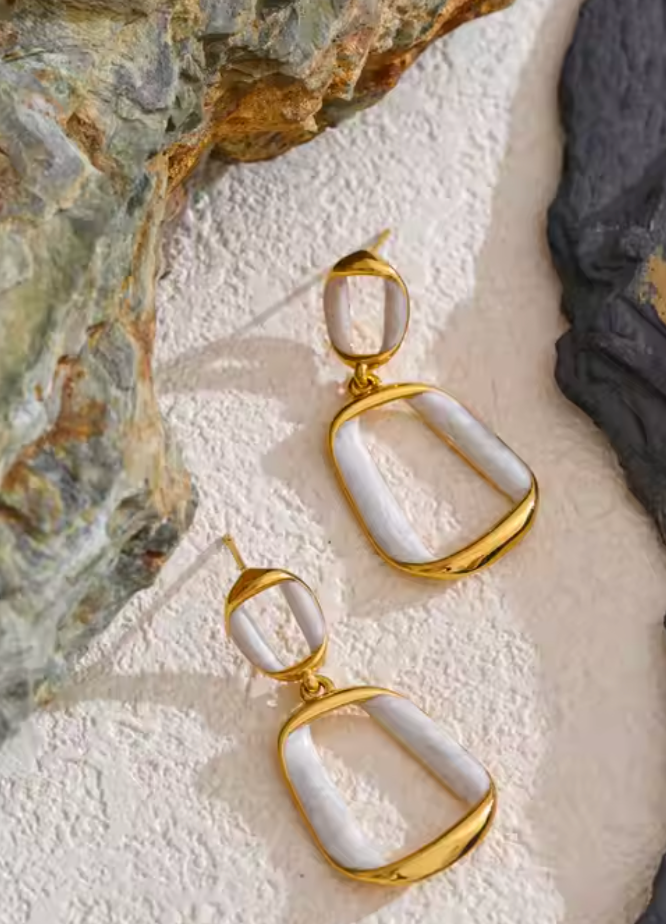 Gold-plated earrings with pearl white enamel in an irregular rectangle shape, featuring a luminous finish and sculptural design from RESORT 444.